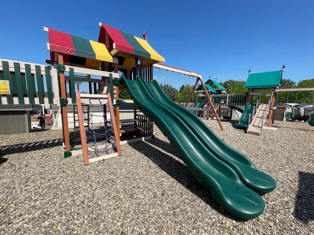 wooden playground with multiple slides