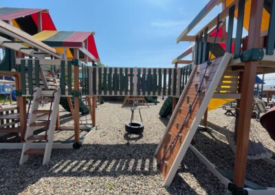 wooden playground with tire swing