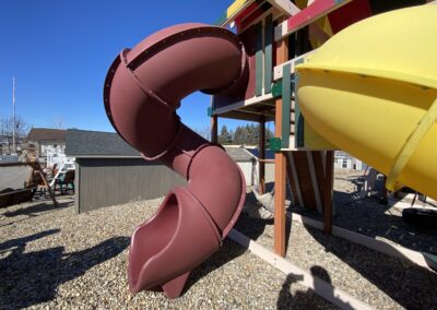 wooden playground with tube slide