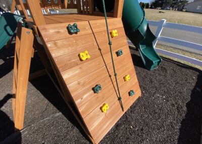 swing set with tube slide and rock climber