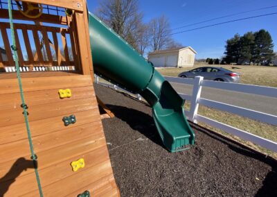 swing set with tube slide and rock climbers