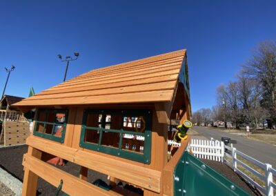 swing set with tube slide and wood roof
