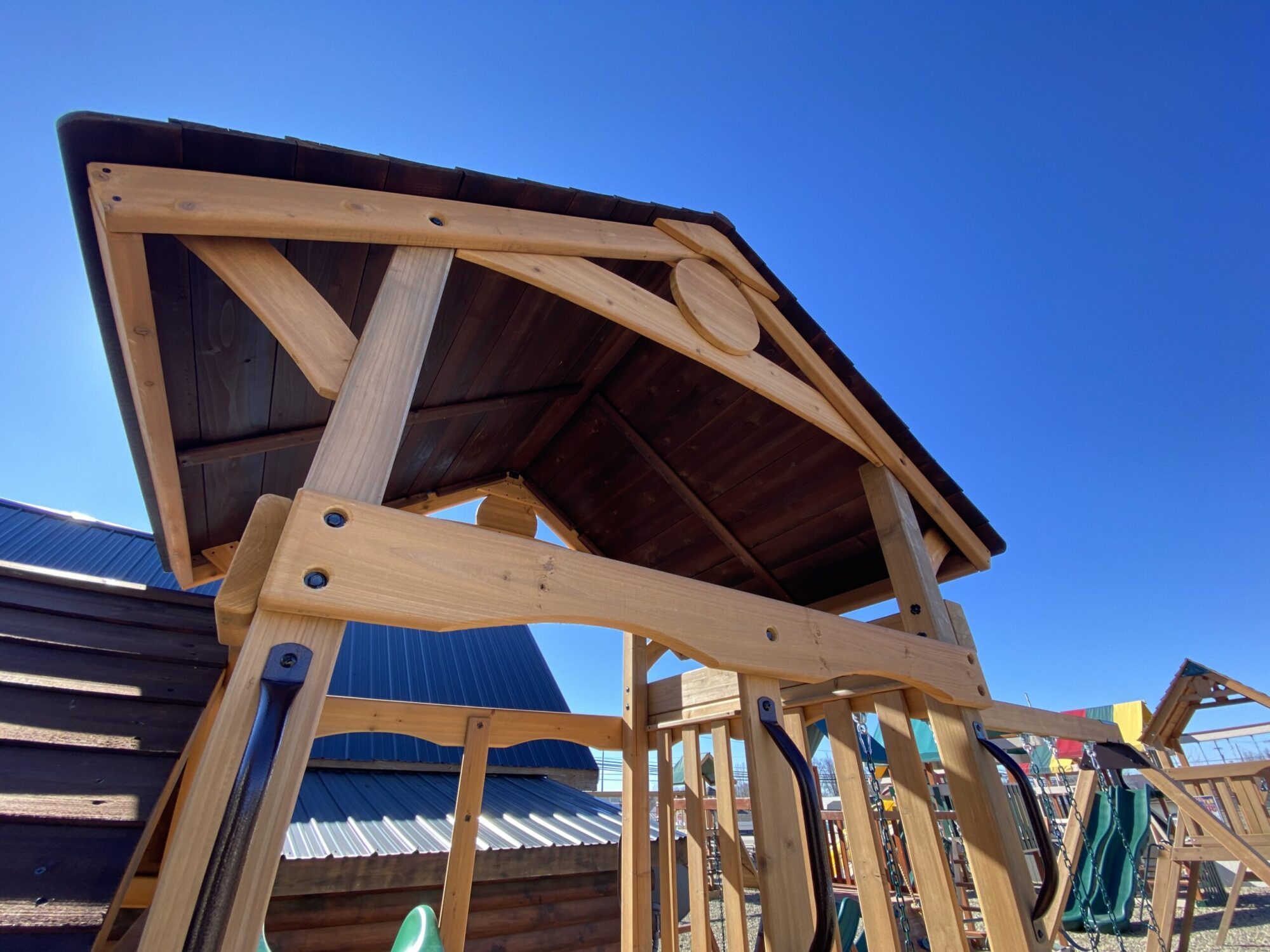 wooden swing set with slide and rock climbers