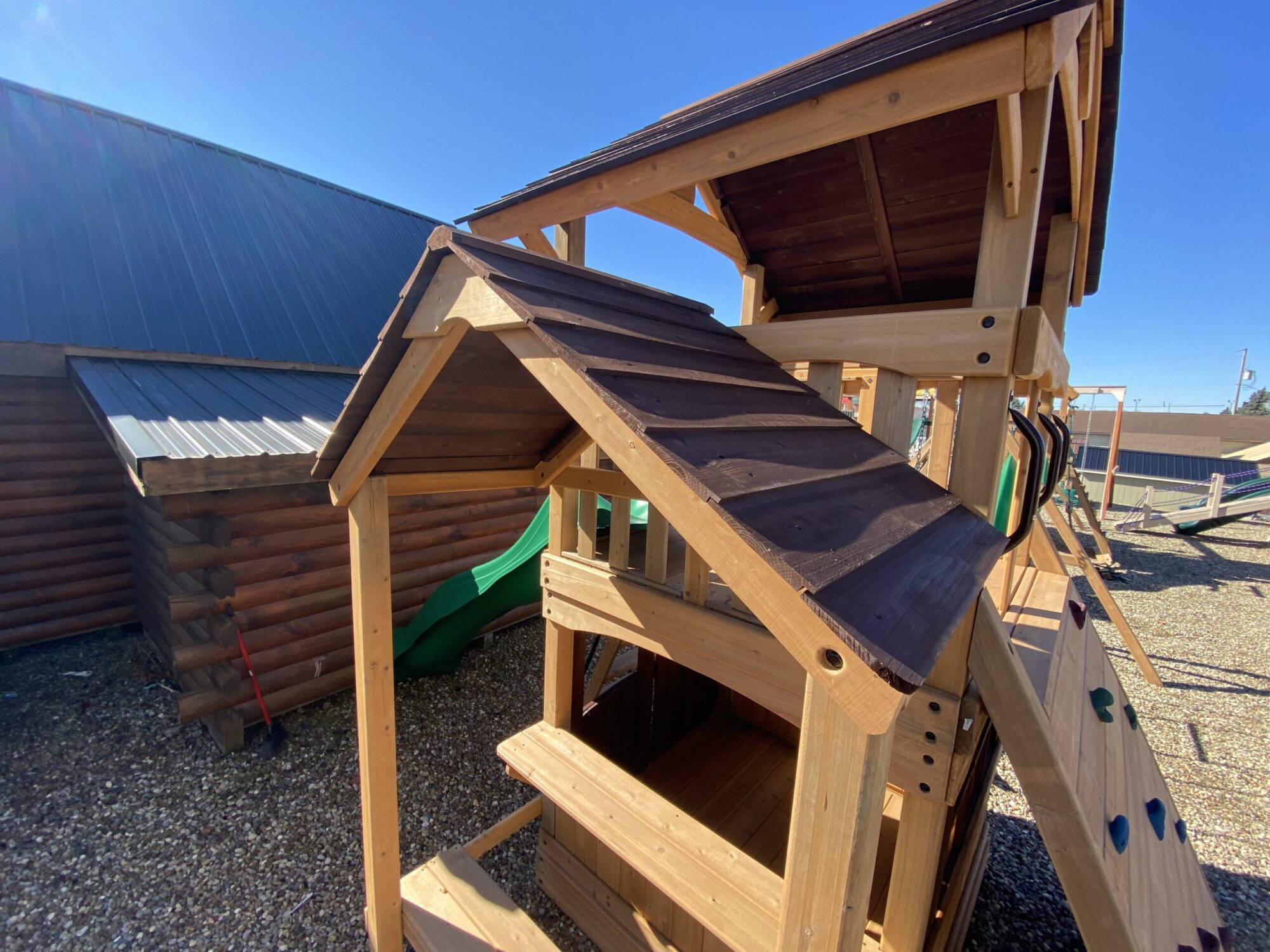wooden swing set with slide with shingled roofing